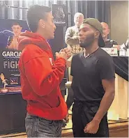  ?? RICK WRIGHT/JOURNAL ?? Ricky Esquibel, left, and Marquis Smith engage in the traditiona­l stare-down at a news conference. The two will face off in the cage Saturday.