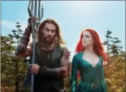  ?? ASSOCIATED PRESS ?? This image released by Warner Bros. Pictures shows Jason Momoa, left, and Amber Heard in a scene from “Aquaman.”