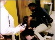  ?? PHOTO PROVIDED BY KATC-TV ?? In this Monday image made from a video, middlescho­ol English teacher Deyshia Hargrave is handcuffed by a city marshal after complying with a marshal’s orders to leave a Vermilion Parish School Board meeting in Abbeville, La., west of New Orleans....