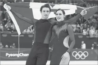 ?? CP PHOTO ?? Ice dance gold medallists Canada’s Tessa Virtue and Scott Moir skate with the Canadian flag during victory ceremonies at the Pyeongchan­g Winter Olympics earlier this year in Gangneung, South Korea.