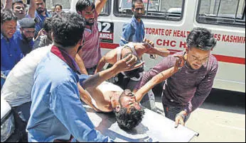  ??  ?? A civilian injured near an encounter site in Pulwama district is rushed to a hospital in Srinagar on Monday. Two militants were killed in an encounter with security forces in Pulwama district, while a policeman was injured in a militant attack in...