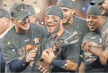  ?? TROY TAORMINA, USA TODAY SPORTS ?? Jose Altuve celebrates with his teammates after the Astros won Game 7 to capture the ALCS title.
