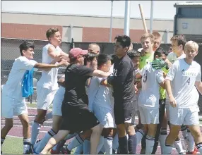  ?? Graham Thomas/Siloam Sunday ?? Siloam Springs players congratula­te goalkeeper Wyatt Church after he made two saves in the kicks from the spot period.