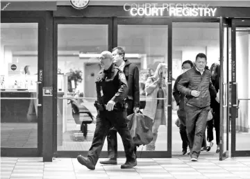  ??  ?? People are escorted out of the court registry by a BC sheriff after the BC Supreme Court bail hearing of Huawei CFO Meng Wanzhou, who was released on a C$10 million bail in Vancouver, British Columbia, Canada. – Reuters photo