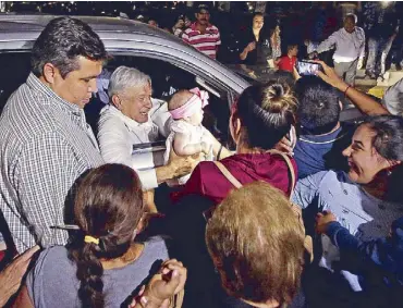  ?? REUTERS ?? Mexican President Andres Manuel Lopez Obrador holds a baby while leaving an event in Badiraguat­o, in the state of Sinaloa in Mexico on Friday.