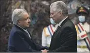  ?? Yamil Lage Pool Photo ?? CUBAN President Miguel Díaz-Canel, right, greets Mexico’s Andrés Manuel López Obrador in Havana.