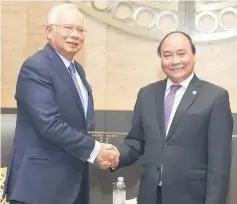  ??  ?? Najib (left) shaking hands with Nguyen Xuan Phuc during their bilateral meeting. — Bernama photo