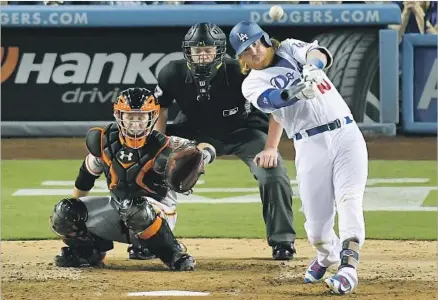  ?? Mark J. Terrill ?? JUSTIN TURNER of the Dodgers hits a home run in the fourth inning, sending the Giants and catcher Buster Posey to another loss.