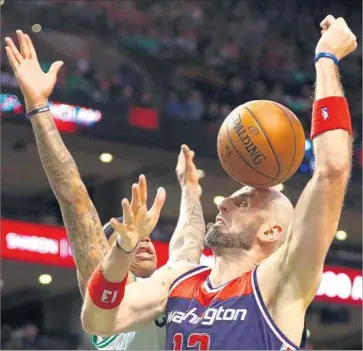  ?? Maddie Meyer Getty Images ?? A LOOSE ball lands on the head of Washington’s Marcin Gortat during a rebound battle with Boston’s Isaiah Thomas during Game 1. Thomas had 33 points and nine assists in the Celtics’ victory.