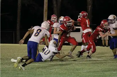  ?? The Sentinel-Record/James Leigh ?? ■ Mountain Pine’s Keelan Dobbins (4) breaks through on a run during last Friday’s game against Spring Hill at Stanley May Field. The Red Devils travel to Strong Friday to take on the Bulldogs.