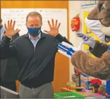  ??  ?? Los Angeles Unified School District Superinten­dent Austin Beutner participat­es in a classroom activity on the first day of in-person learning at Heliotrope Avenue Elementary School.