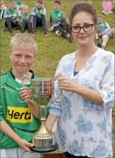  ??  ?? Gina Carthy presenting the Jack Carthy Memorial Cup to Kevin O’Mahony, the Forth Celtic captain.