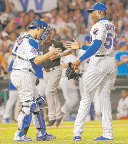  ?? | CHARLES REX ARBOGAST/AP ?? Miguel Montero and Aroldis Chapman celebrate the Cubs’ victory Wednesday against the White Sox.