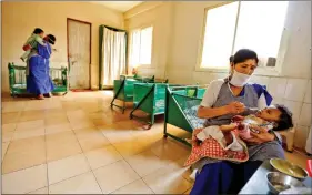  ?? Of representa­tion) REUTERS (Picture for the purpose ?? Nurses care for abandoned infants at a facility in Delhi on 1 March.