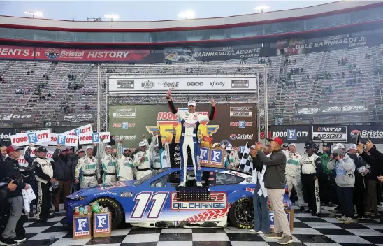  ?? MEG OLIPHANT/GETTY IMAGES ?? Denny Hamlin, driver of the #11 Express Oil Change Toyota, celebrates in victory lane after winning the NASCAR Cup Series Food City 500 at Bristol Motor Speedway.