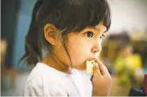  ??  ?? Bianca Murias, 3, has a snack after a nap last week at River Center Early Head Start.