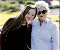  ?? Arkansas Democrat-Gazette/THOMAS METTHE ?? Laurie Jernigan (right), mother of Ebby Steppach, gets a hug from Danielle Westbrook, Steppach’s best friend, during a ceremony Sunday at Chalamont Park in Little Rock.