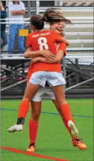  ??  ?? Perkiomen Valley’s Maggie Sell, facing, gets a hug from teammate Samantha Penny after scoring a goal from 25 yards out in the second half Monday against Pottsgrove.
