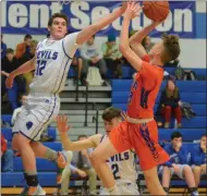  ??  ?? Camden senior Josh Leos defends a shot attempt by Oneida junior Riley Wallis during Tri-Valley League action in Camden on Tuesday, Jan. 14.