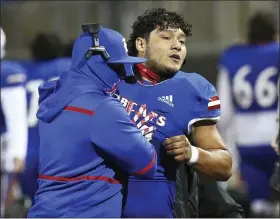  ?? JOEL MARTINEZ — THE ASSOCIATED PRESS ?? Edinburg’s Emmanuel Duron is pulled from the field by coaching staff after charging a referee during a high school football zone play-in game against Pharr-San Juan-Alamo on Dec. 3 in Edinburg, Texas.
