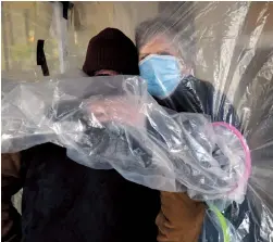  ??  ?? Lynda Hartman, 75, embraces her 77-year-old husband Len Hartman, who suffers from dementia in a hug tent.