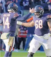  ?? ?? Andy Dalton (14) celebrates his touchdown pass to Darnell Mooney with James Daniels (68) after Dalton was pressed into duty when Justin Fields left the game with a rib injury and did not return.