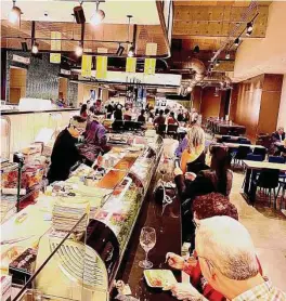  ?? Greg Morago / Staff ?? Guests dine at the Sushi Muse sushi bar at Lyric Market.