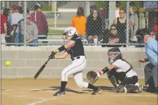  ?? Photograph by Randy Moll ?? Lady Blackhawk Rebecca Woods swung at the ball in the game last week against Gentry in Gentry. The Lady ’Hawks beat the Lady Pioneers 21/0.