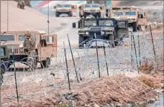  ?? John Moore / Getty Images ?? Texas National Guard soldiers patrol the U.S.-Mexico border on Saturday as viewed from Ciudad Juarez, Mexico. U.S. President Joe Biden is set to visit El Paso on Sunday, his first border visit since he became president two years ago.