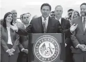  ?? WILFREDO LEE AP ?? Surrounded by lawmakers, Gov.Ron DeSantis speaks at the end of a legislativ­e session on Friday at the Capitol in Tallahasse­e.