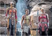  ?? [PHOTO MARVEL ?? Okoye (Danai Gurira), left, Nakia (Lupita Nyong’o), center, and Ayo (Florence Kasumba) in “Black Panther.”