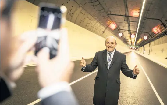  ?? Picture / Michael Craig ?? Finance and Infrastruc­ture Minister Steven Joyce poses for a snap in the Waterview Tunnel. While the tunnel will stand as a visible legacy for politician­s, its promised benefits may be muted if it turns out to be vulnerable to congestion.