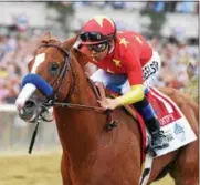  ?? PHOTO ADAM MOOSHIAN/NYRA ?? Justify with Mike Smith aboard on his way to winning the 2018 Belmont Stakes and becoming the 13th Triple Crown winner.