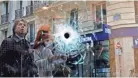  ?? THIBAULT CAMUS/AP ?? A bullet hole marks the window of a cafe Sunday in Paris near the area where the assailant in a knife attack was shot dead by police officers.