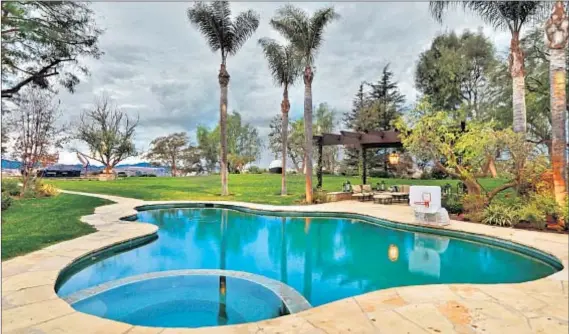  ?? Photograph­s courtesy of Paul Jonason Photograph­y ?? BESIDES A POOL, the grounds on Dr. Dre’s newly acquired Calabasas estate have a sports court, a fire pit and a barbecue center.