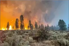  ?? Photo by USDA Forest Service via Getty Images ?? The Bootleg Fire burns Monday in Bly, Ore. The fire has spread over 212,377 acres, making it the largest among the dozens of blazes burning in the Western U.S. fueled by record temperatur­es and drought.