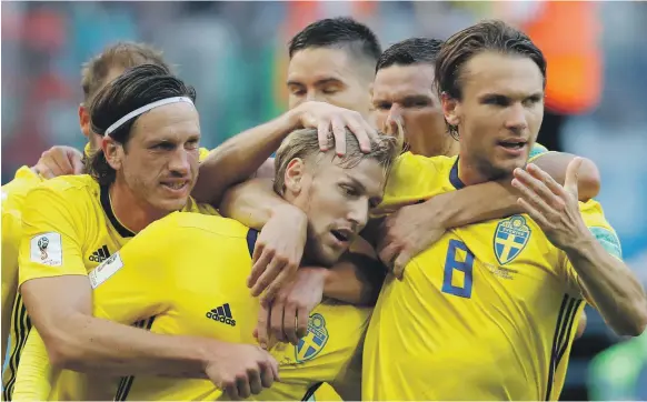  ?? AP ?? Emil Forsberg, centre, celebrates with teammates after scoring the winner for Sweden against Switzerlan­d in the last 16 tie