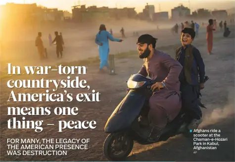  ?? AP ?? Afghans ride a scooter at the Chaman-e-Hozari Park in Kabul, Afghanista­n