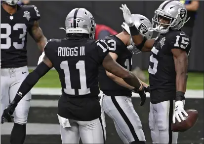  ?? DAVID BECKER — THE ASSOCIATED PRESS ?? Las Vegas Raiders wide receiver Henry Ruggs III (11) celebrates after wide receiver Nelson Agholor (15) scored a touchdown against the Indianapol­is Colts on Sunday in Las Vegas.