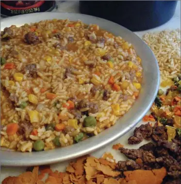  ?? GLENN MCALLISTER VIA AP ?? The dehydrated ingredient­s for bean bark stew at lower right, and the prepared stew, top.