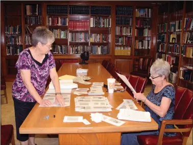  ?? Janice McIntryre/News-Times ?? Saving history: Carolyn Smith, left, and Jan Fournier, members of the Union County Genealogic­al Society, are working on a project to save and file obituaries at Barton Library in El Dorado.