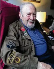  ?? MARK DAVIS / AJC ?? Irving Feinberg kept his WWII Army jacket. Attached to it is the French Legion of Honour medal.