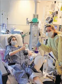  ?? OF DENISE TIMS PHOTO COURTESY ?? Megan Tims waits for her new lungs, with the encouragem­ent of Christina Rothenburg Norberg (right). Both local women got lung transplant­s at Duke Medical Center in the fall of 2015.