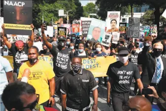  ?? Wes Bruer / AFP via Getty Images ?? Demonstrat­ors gather at a rally organized by the NAACP outside the Georgia Capitol in Atlanta to protest the fatal police shooting of Rayshard Brooks and to demand social justice.