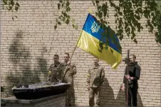  ?? ?? meople attend a May 12 funeral for soldier Maksym “Shram” vakovenko, who was killed on the front on May S.