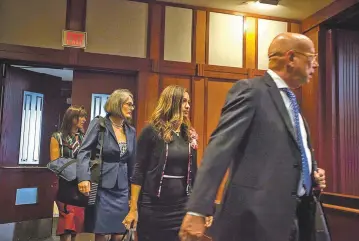  ?? JUAN ANTONIO LABRECHE/FOR THE NEW MEXICAN ?? New Mexico state Rep. Monica Youngblood, center, and her attorneys enter the courtroom Tuesday in Albuquerqu­e.