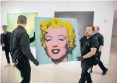  ?? TED SHAFFREY/AP ?? An unknown buyer purchased the 1964 painting “Shot Sage Blue Marilyn” by Andy Warhol for about $195 million at auction on Monday at Christie’s in New York City.