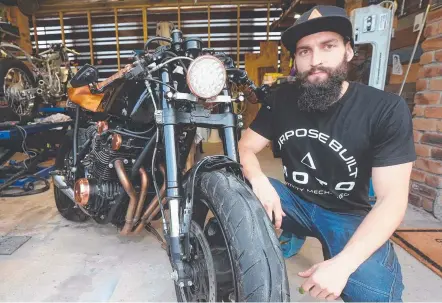  ?? Picture: MIKE BATTERHAM ?? Tom Gilroy of Purpose Built Moto gets a couple of bikes ready for the Motosocial Show’n’Shine on Sunday.