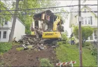  ?? Lori Van Buren / Times Union ?? A house at 865 Myrtle Ave., in Albany is knocked down Tuesday after being deemed unsafe. Parts of the floor had collapsed into the basement.