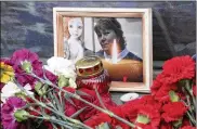  ??  ?? A photo of Irina Medyantsev­a, a victim of the subway explosion, is displayed at a memorial Wednesday in St. Petersburg, Russia. Relatives said she died after throwing herself onto her daughter to save her from the blast.